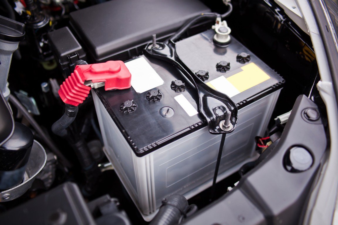 Car battery mounted in an engine bay awaiting a charge check