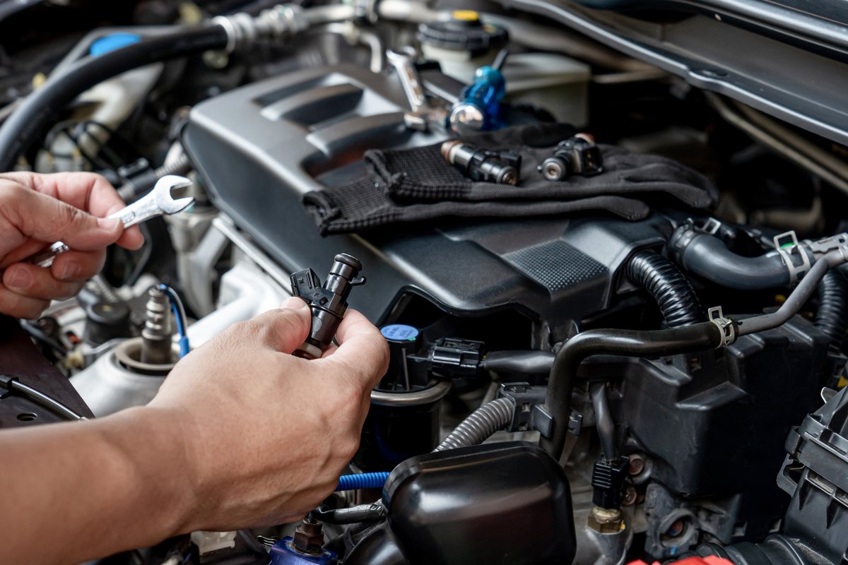 Technician servicing the air intake and throttle components on an engine
