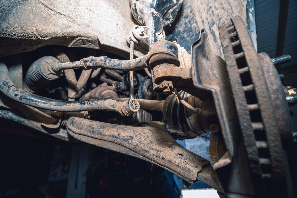 Tie rod and ball joint steering components viewed from under a vehicle